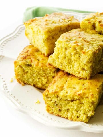 serving platter with squares of Cajun cornbread.