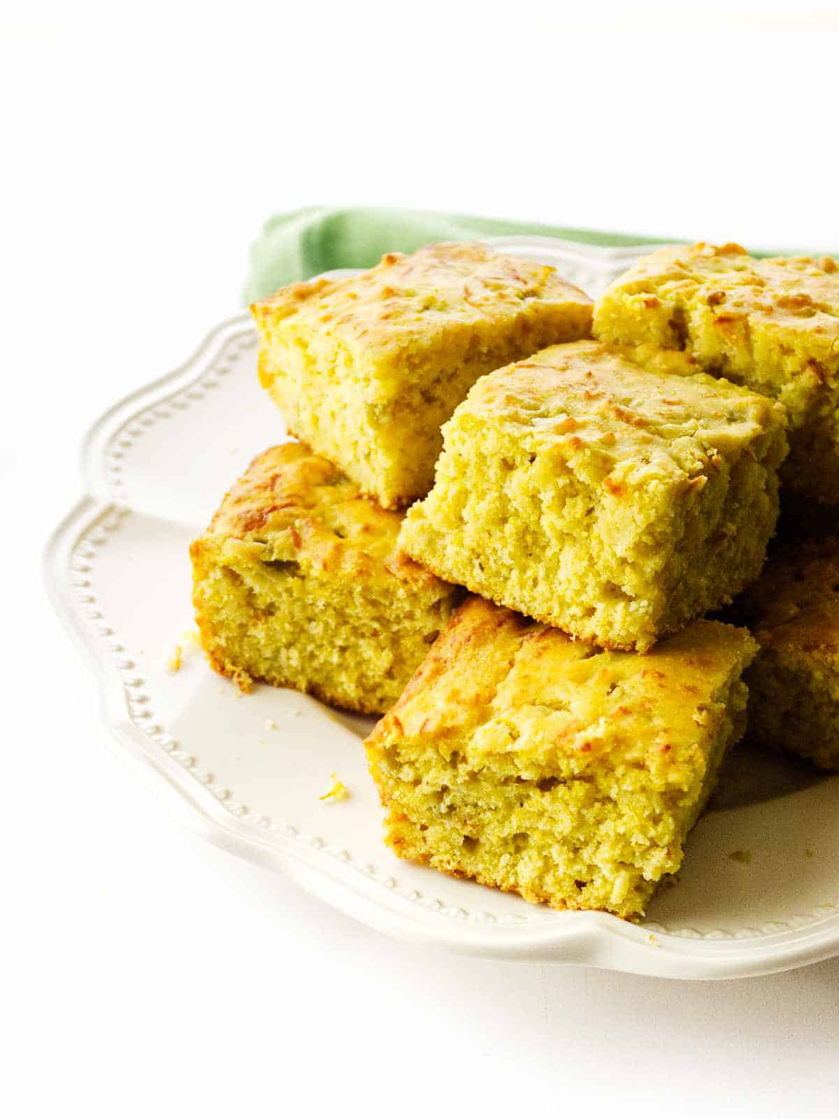 serving platter with squares of Cajun cornbread.