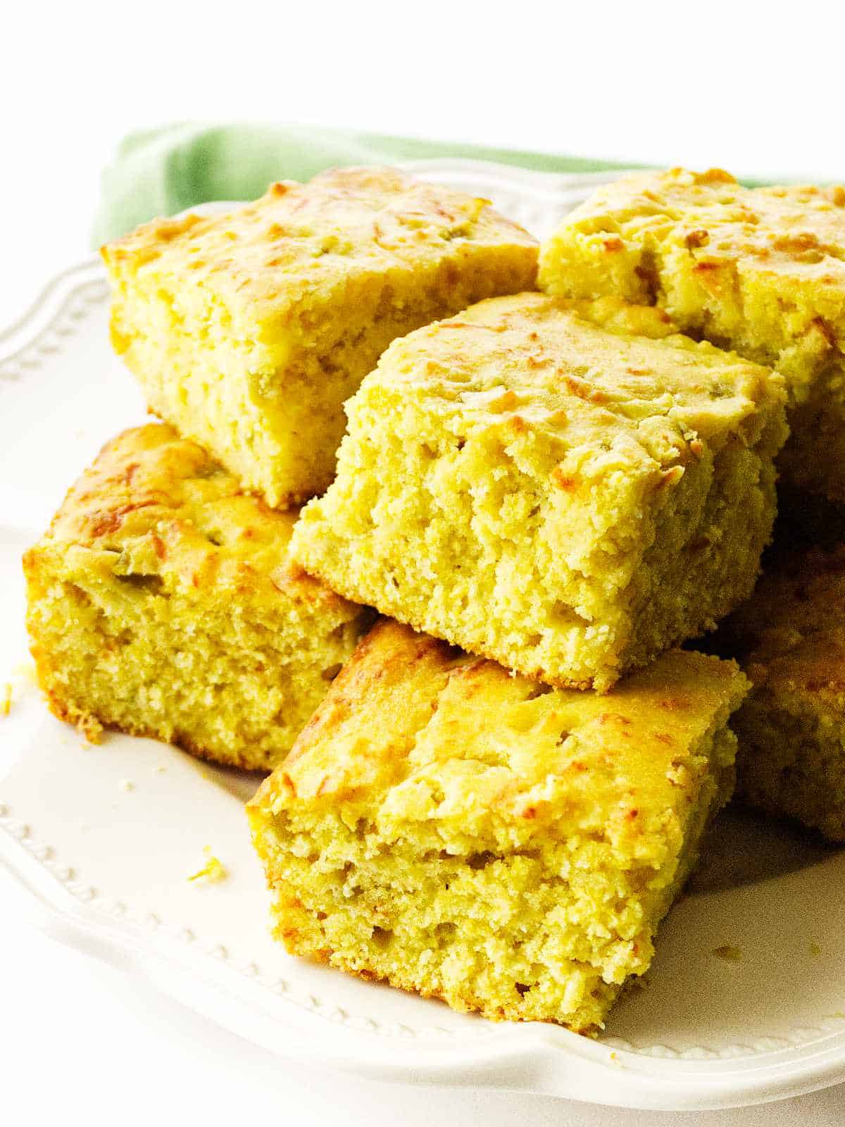 serving platter with squares of Cajun cornbread.