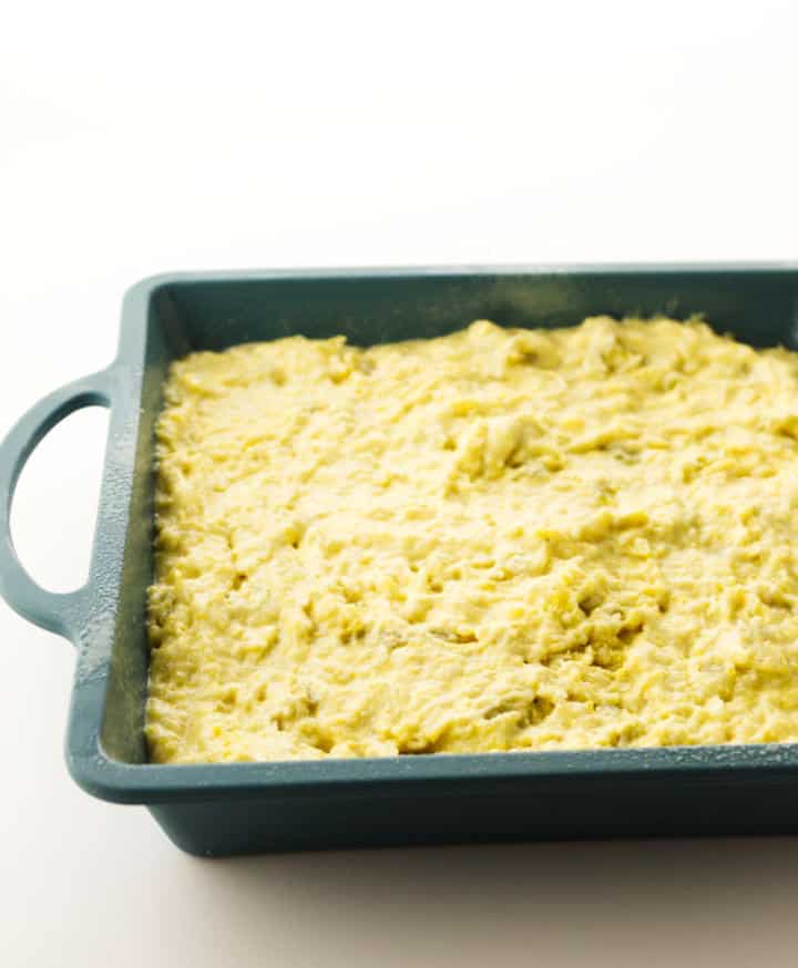 cornbread batter in a square baking pan.