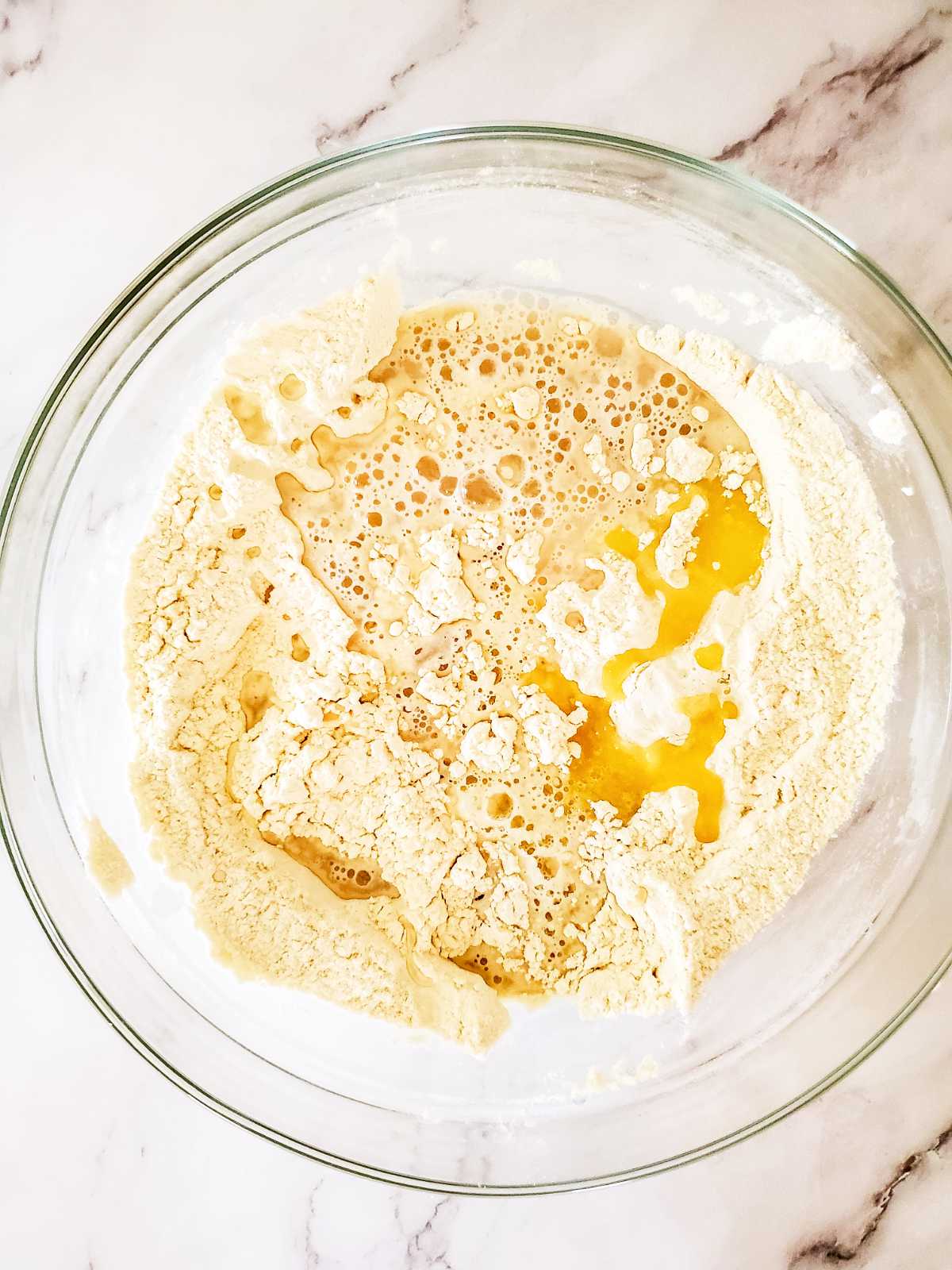 mixing proofed yeast with flour.