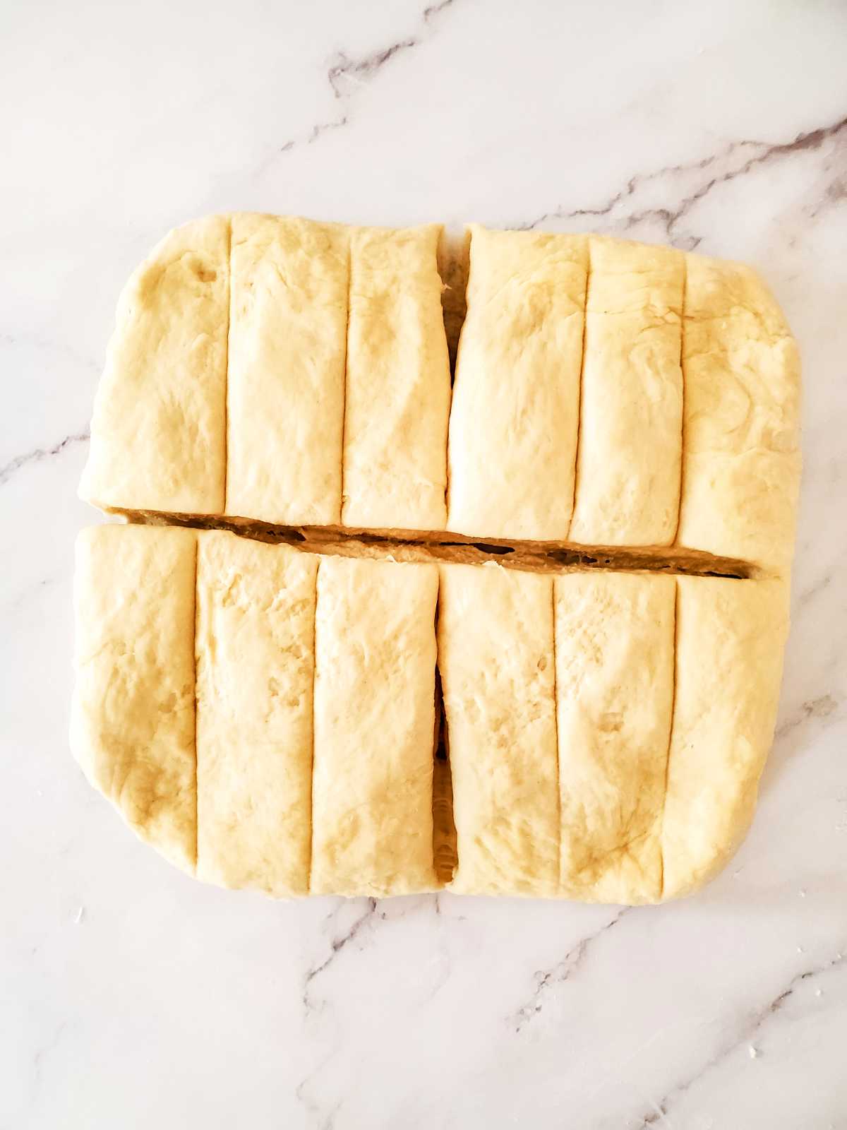 cutting dough for breadsticks.