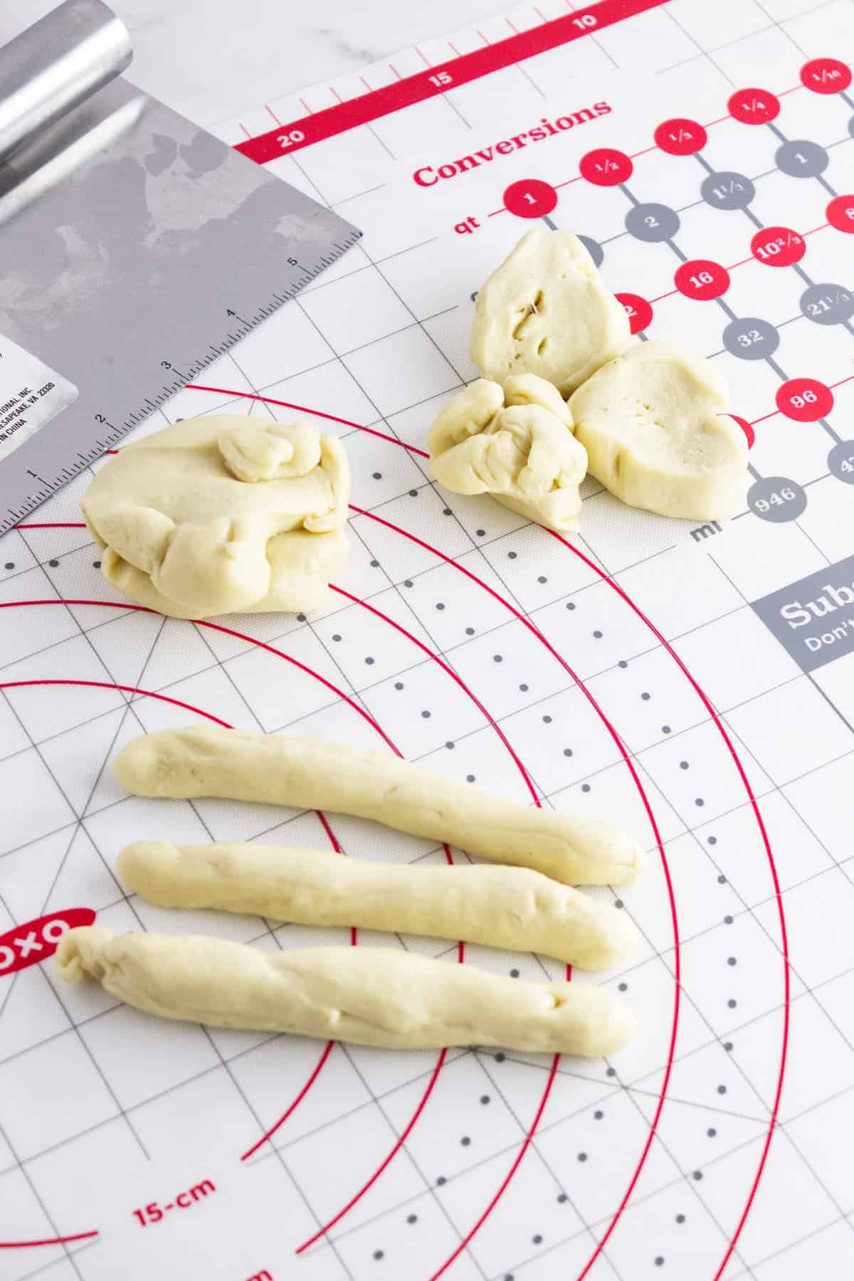 shaping dough on a work surface.