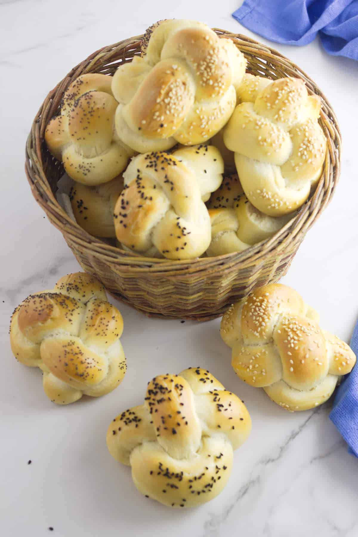 basket of golden brown, seeded challah rolls.