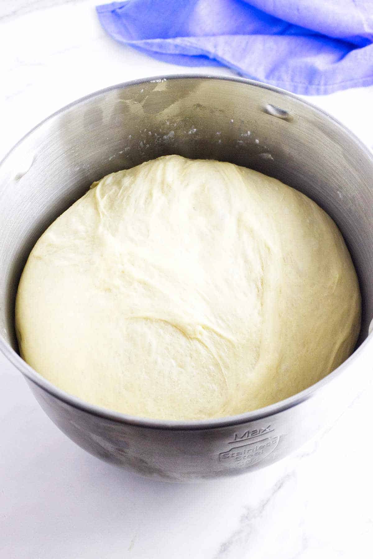 Bowl of risen bread dough.