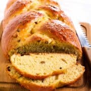 Challah with raisins sliced on a cutting board.