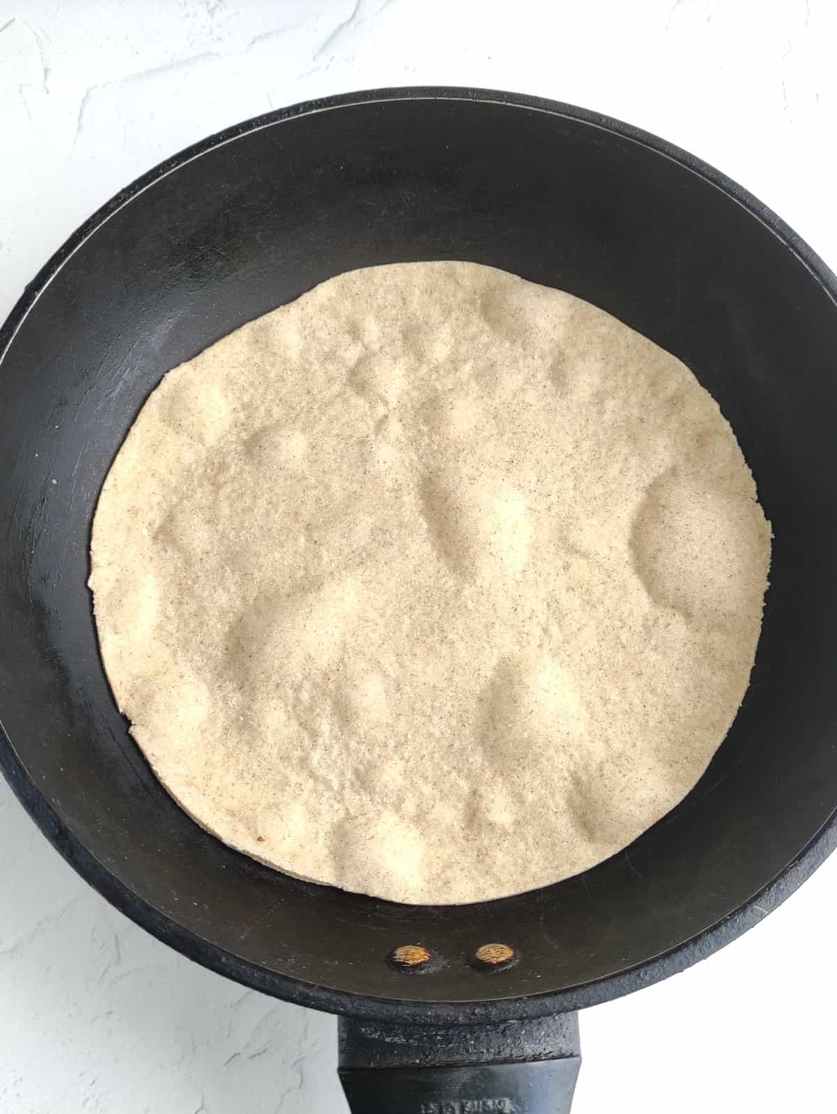 homemade tortilla in a skillet.