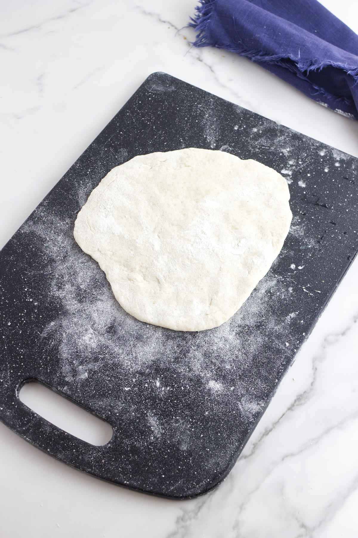 flattening a ball of dough.