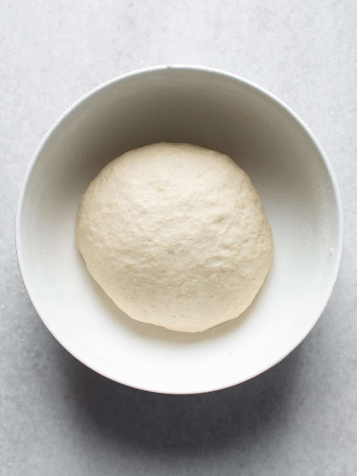 Ball of dough set in a bowl to rise.