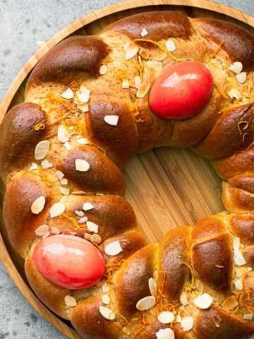 Greek Easter Tsoureki bread wreath with red eggs tucked into it.