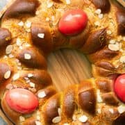 Greek Easter Tsoureki bread wreath with red eggs tucked into it.