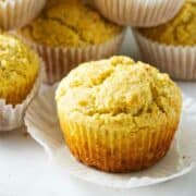 cornbread muffins with wrappers stacked up.