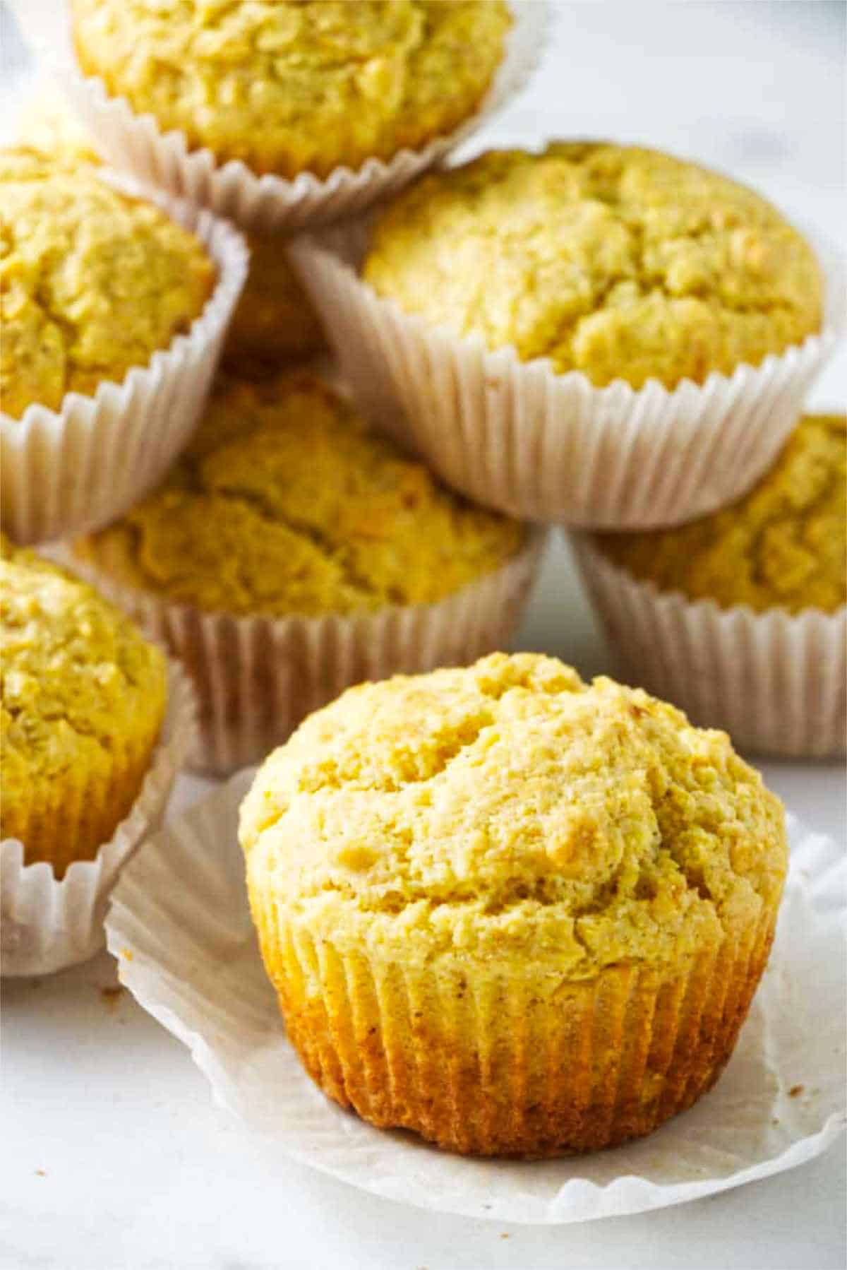 cornbread muffins with wrappers stacked up.