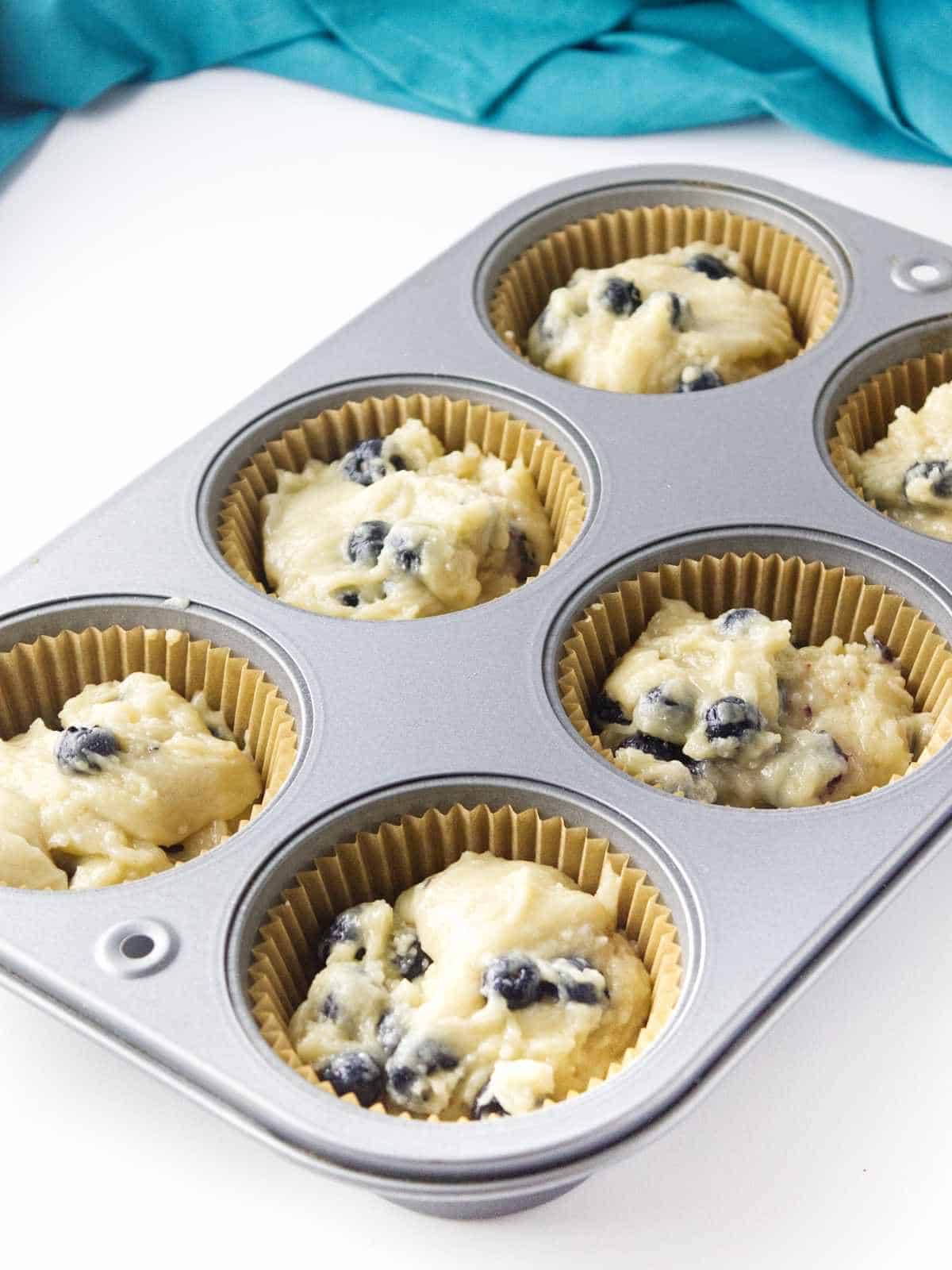 Muffin batter in Jumbo a bakery style size muffin tin.