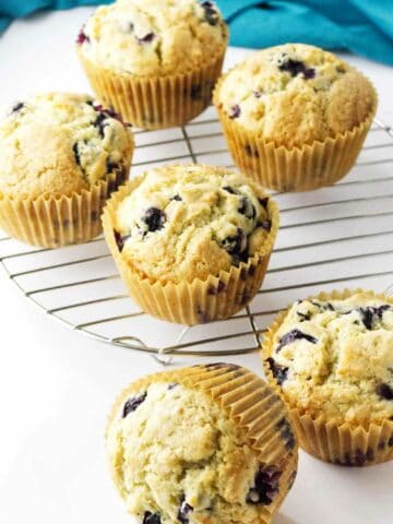 Jumbo blueberry muffins cooling on a rack.