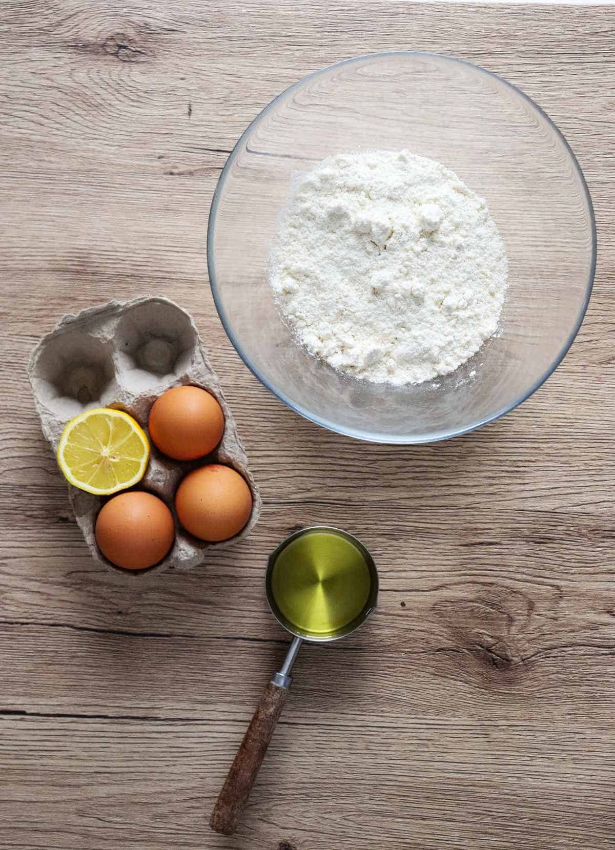 flour in a bowl with eggs to the side.