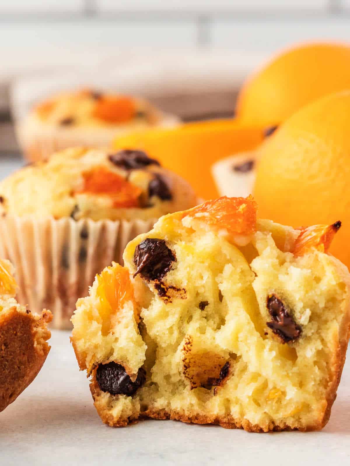 Split orange muffin showing chocolate chips.