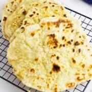 sourdough discard naan flatbreads on a cooling rack.