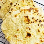 sourdough discard naan flatbreads on a cooling rack.