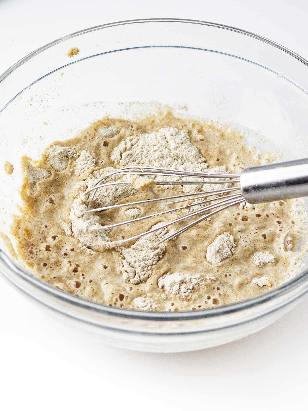flour and water mixed in a bowl to prepare a preferment.