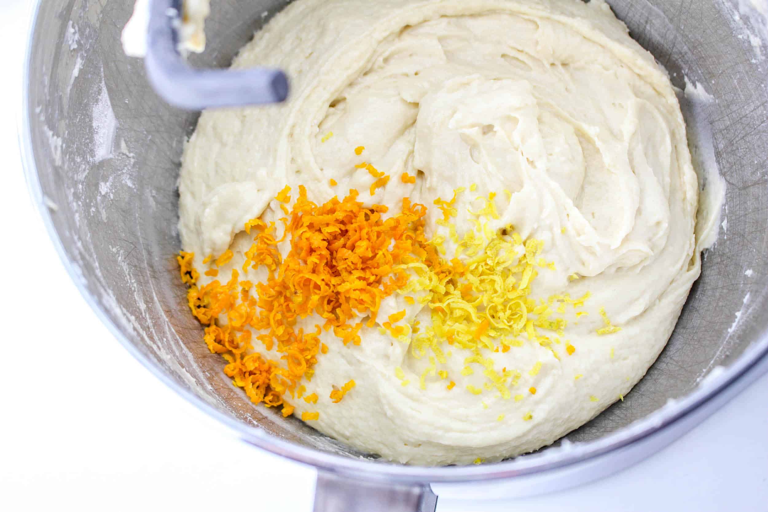 adding orange and lemon zest to panettone dough.