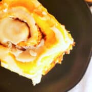 icing drizzled over brown butter cinnamon rolls.