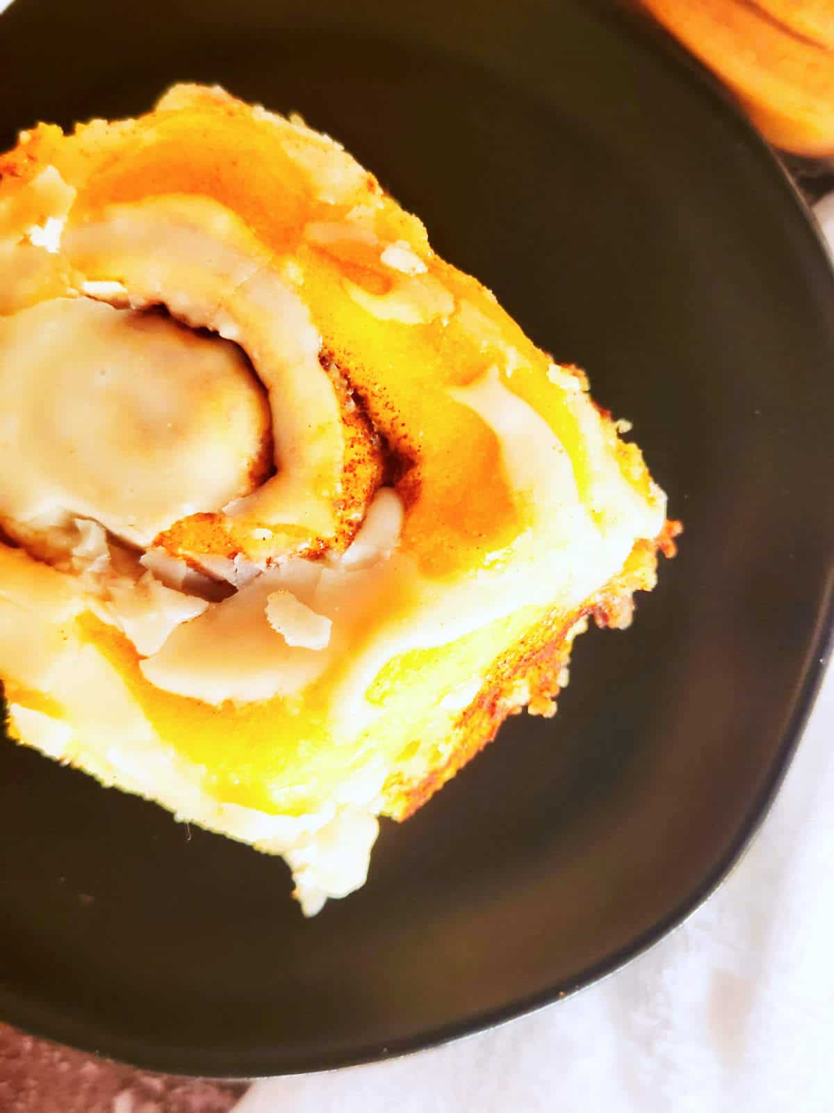 icing drizzled over brown butter cinnamon rolls.