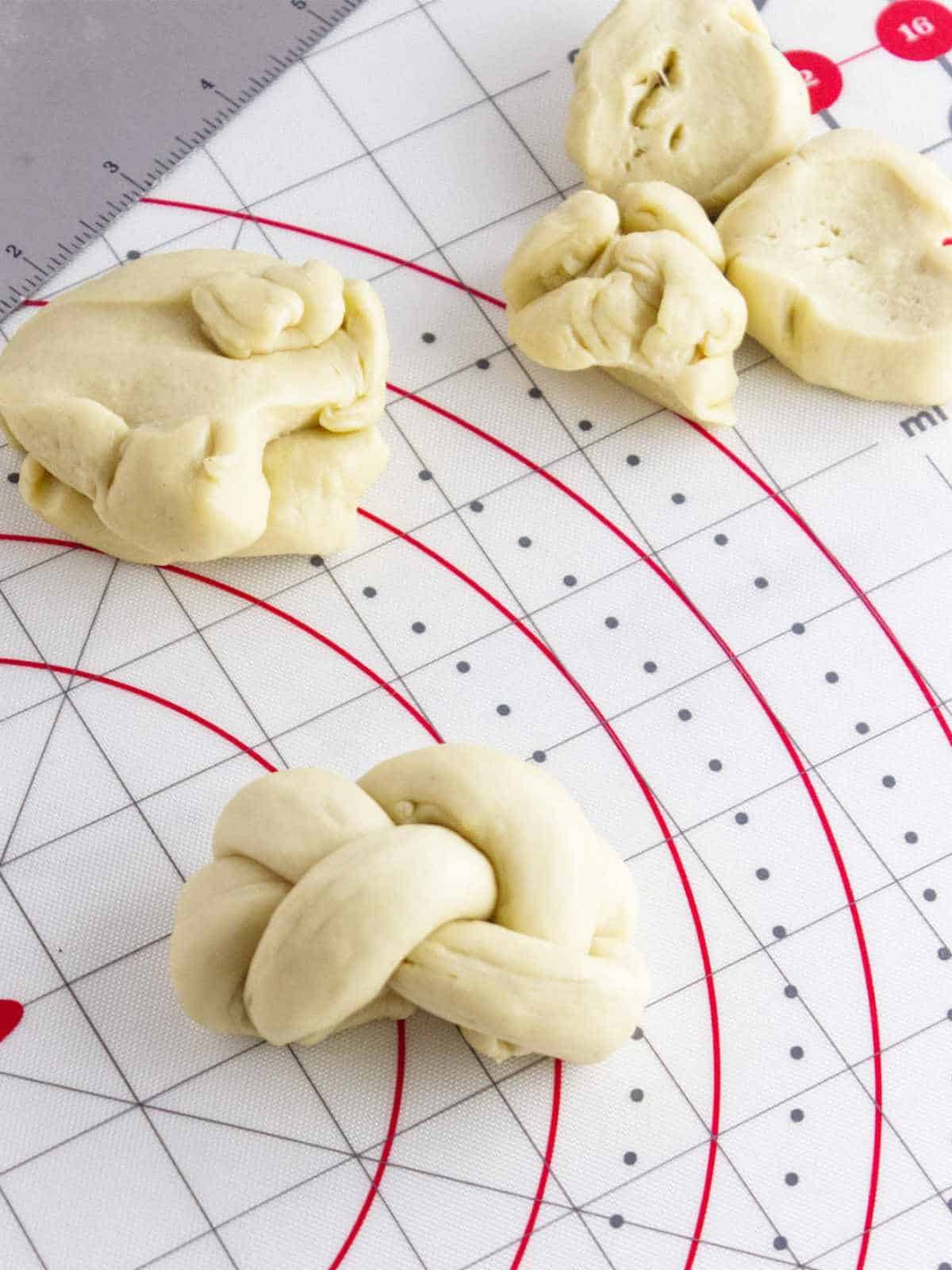 challah rolls with braided ends tucked under.