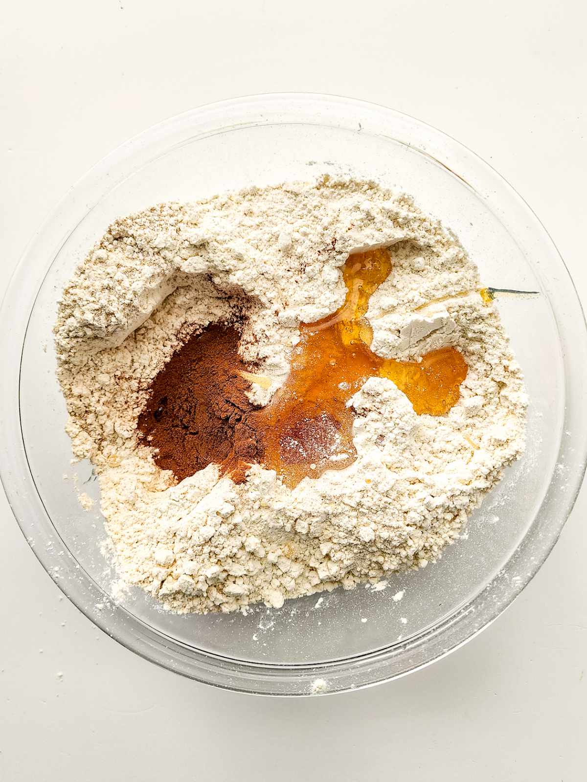 Adding wet ingredients to the dry ingredients in a bowl.