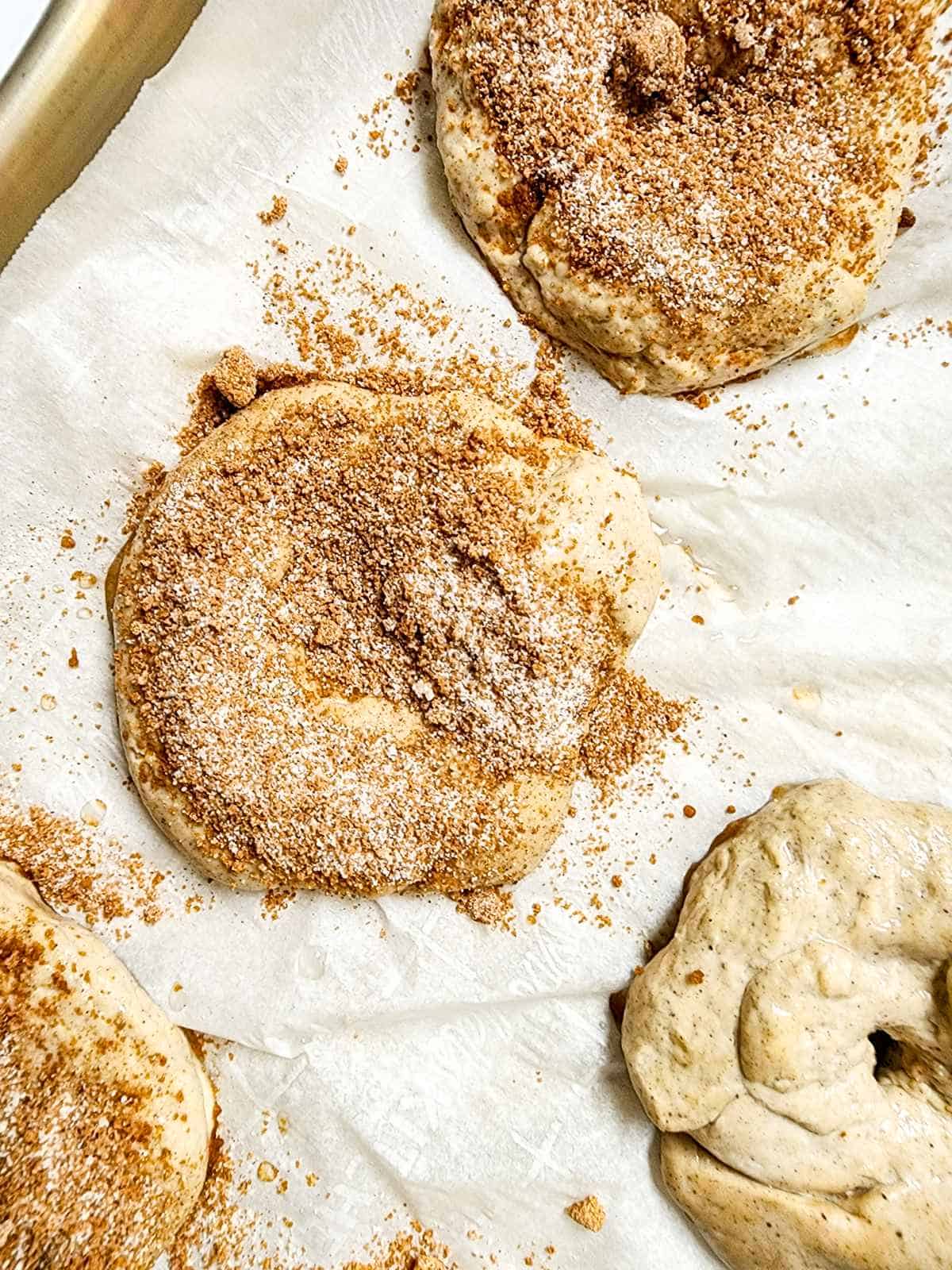 cinnamon crunch topping on top of boiled bagels.