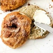 cinnamon bagels split with cream cheese spread.