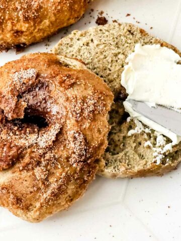 cinnamon bagels split with cream cheese spread.