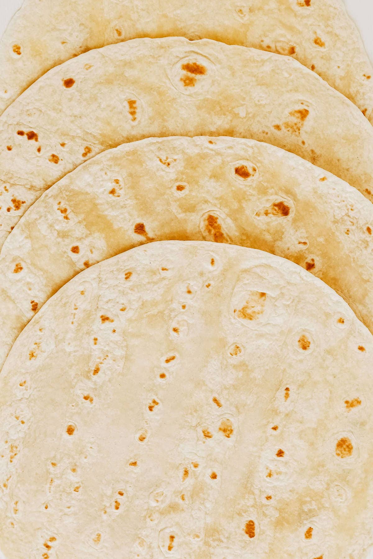 soft flour tortilla on a white wooden table background.