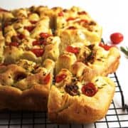 roasted garlic focaccia bread cooling on a wire rack.