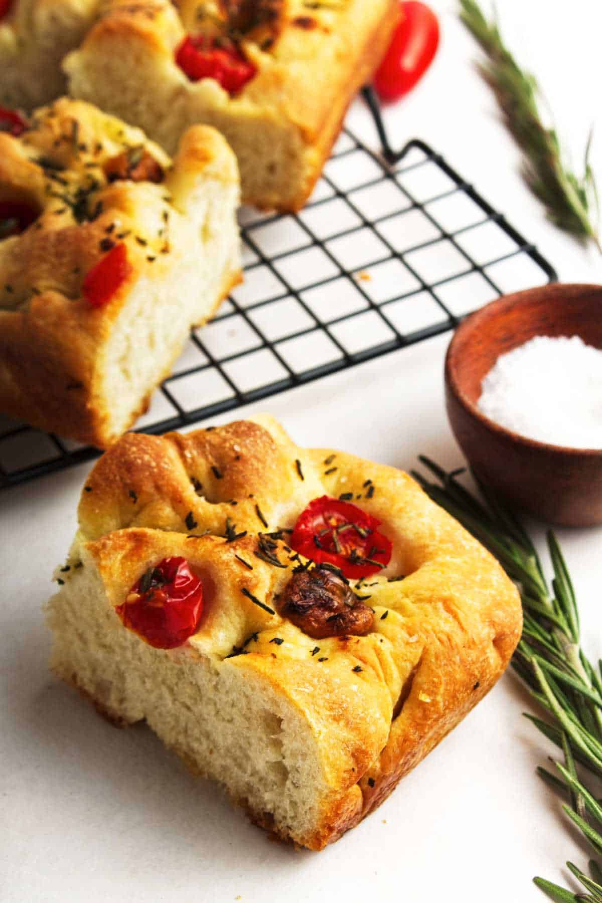 roasted garlic focaccia bread cooling on a wire rack.