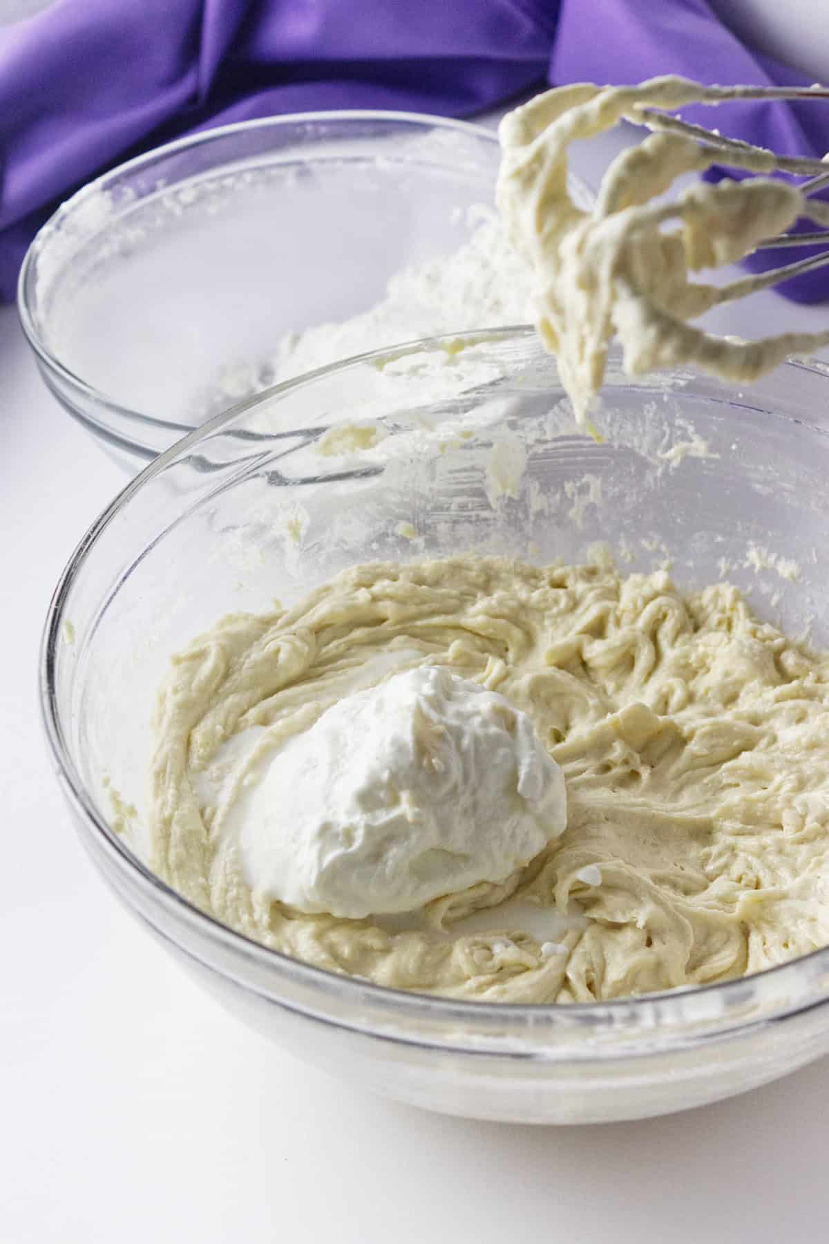 mixing up a loaf bread batter in a bowl.