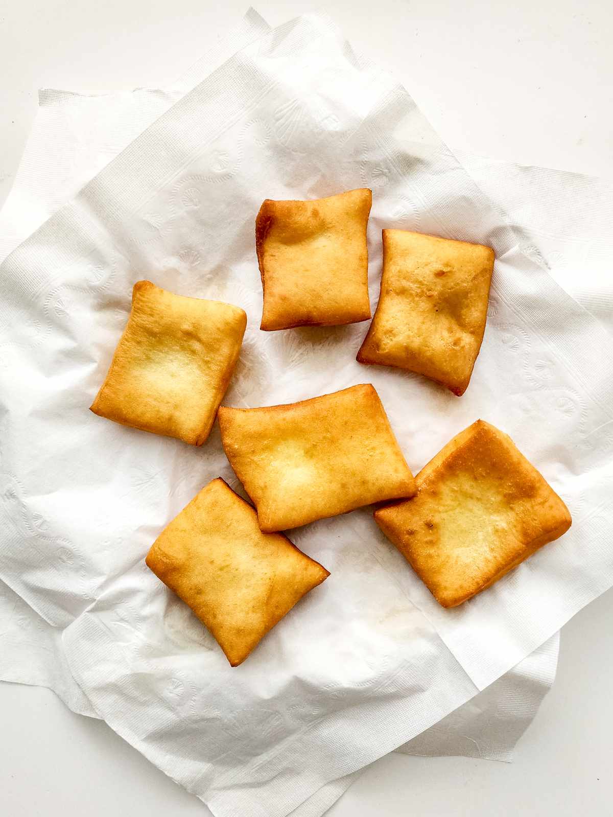 fried dough transferred to absorbent toweling.