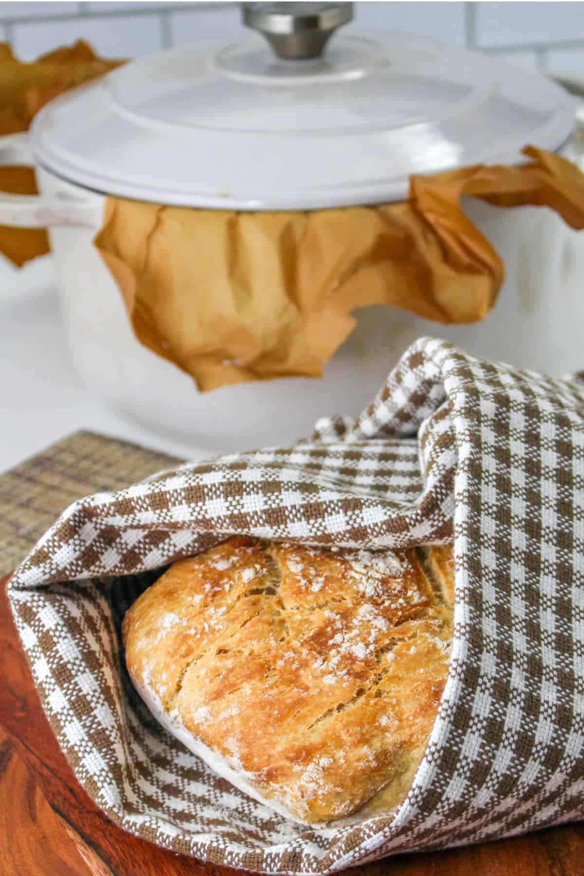 no knead dutch oven bread wrapped in a towel.