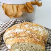 no knead dutch oven bread wrapped in a towel.