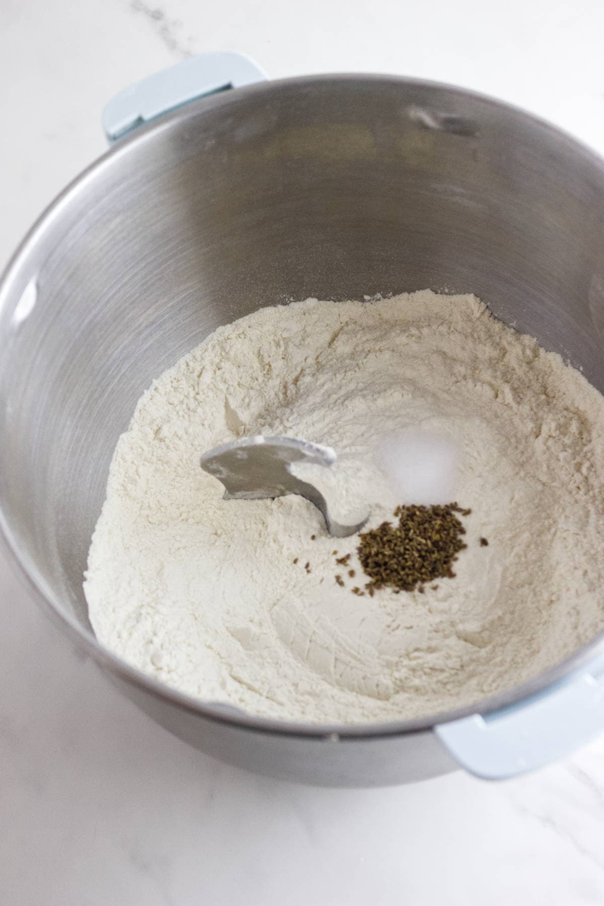 mixing ingredients in a mixer for dough.