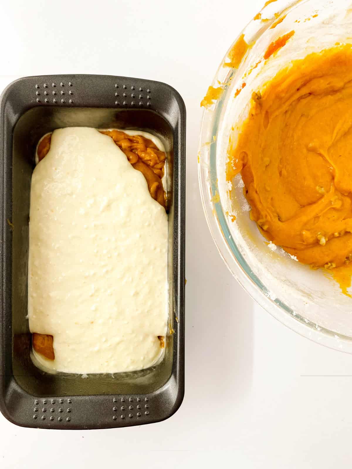 layering pumpkin batter and cream cheese batter in a loaf pan.