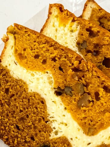 slices of pumpkin cream cheese bread on paper.