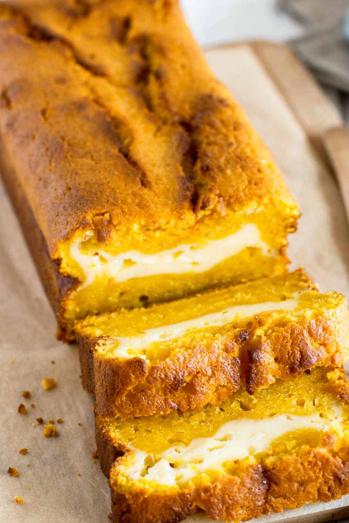 slices of pumpkin cream cheese bread on paper.