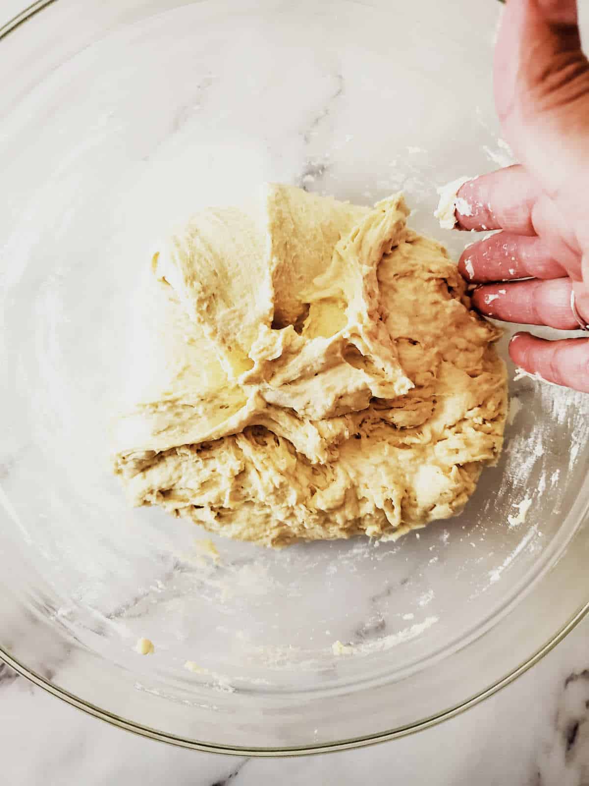 stiching dough in a bowl.