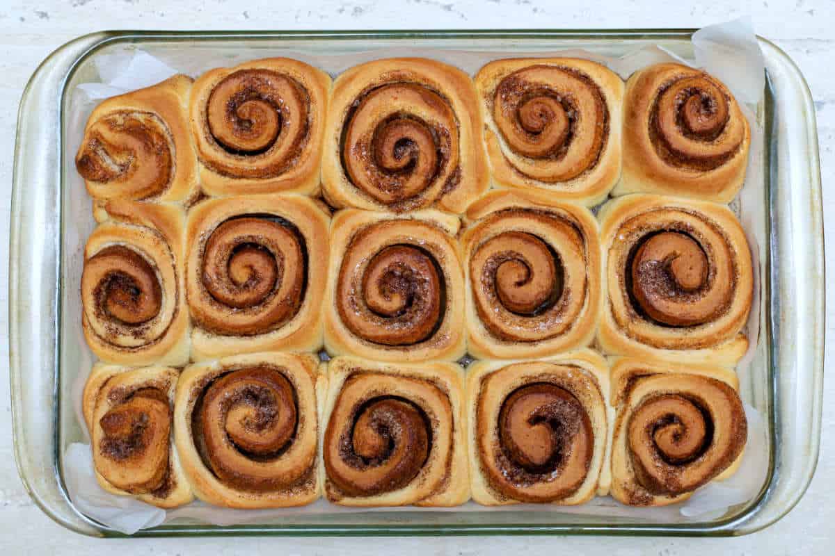 Homemade sourdough discard cinnamon rolls. Freshly cooked buns in a dish.