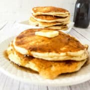 sourdough discard pancakes on a plate with butter and maple syrup.