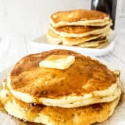 sourdough discard pancakes on a plate with butter and maple syrup.