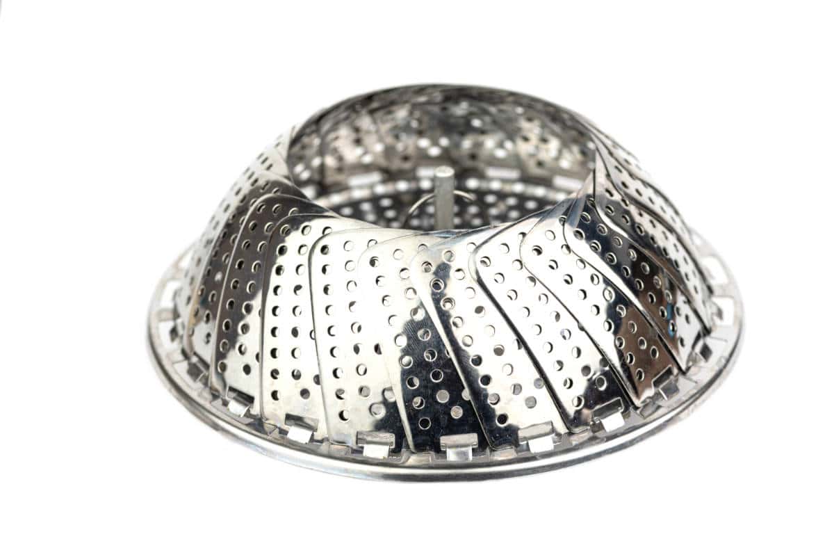 A metal collapsible steamer basket with perforated panels, partially expanded, ideal for steaming treats like Pink Rose Mantou, shown against a white background.