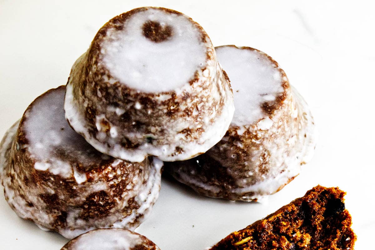 A group of glazed Sailor Jack muffins showing their rounded tops and dark, raisin-studded interiors.