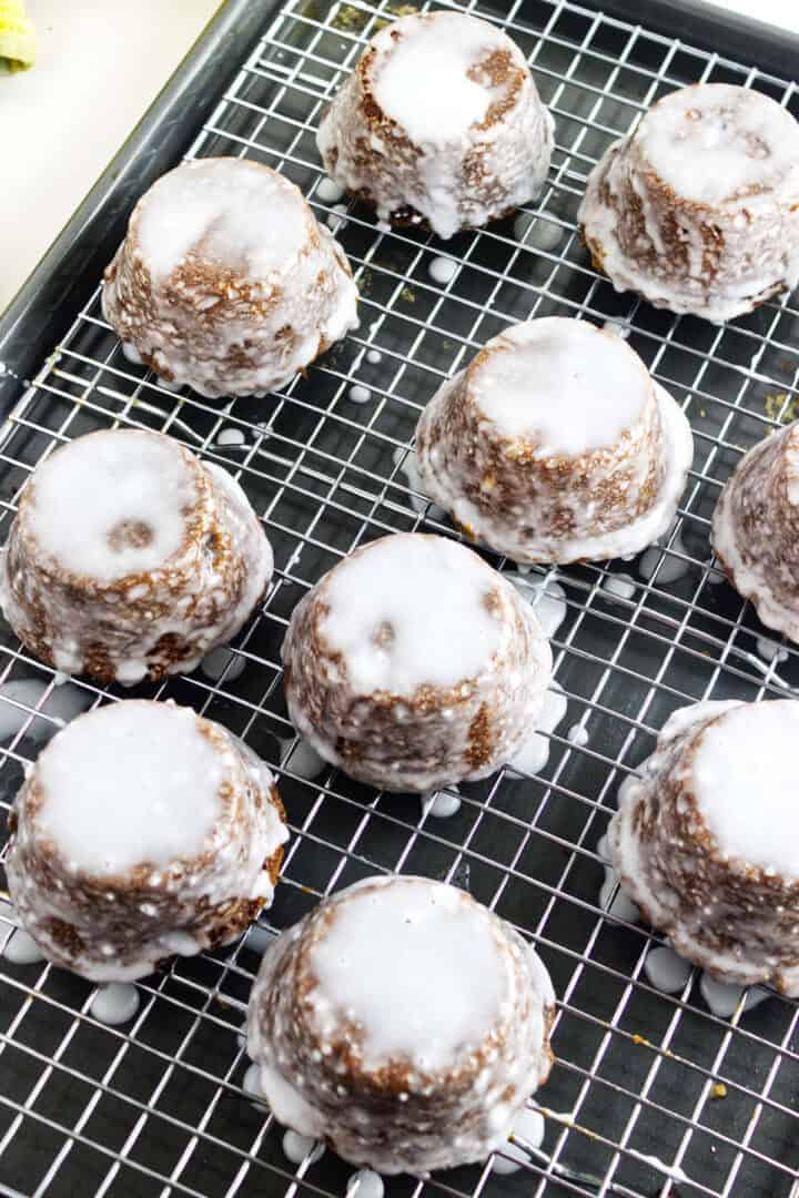 Upside-down Sailor Jack cakes with white glaze setting on a wire rack over a baking sheet.